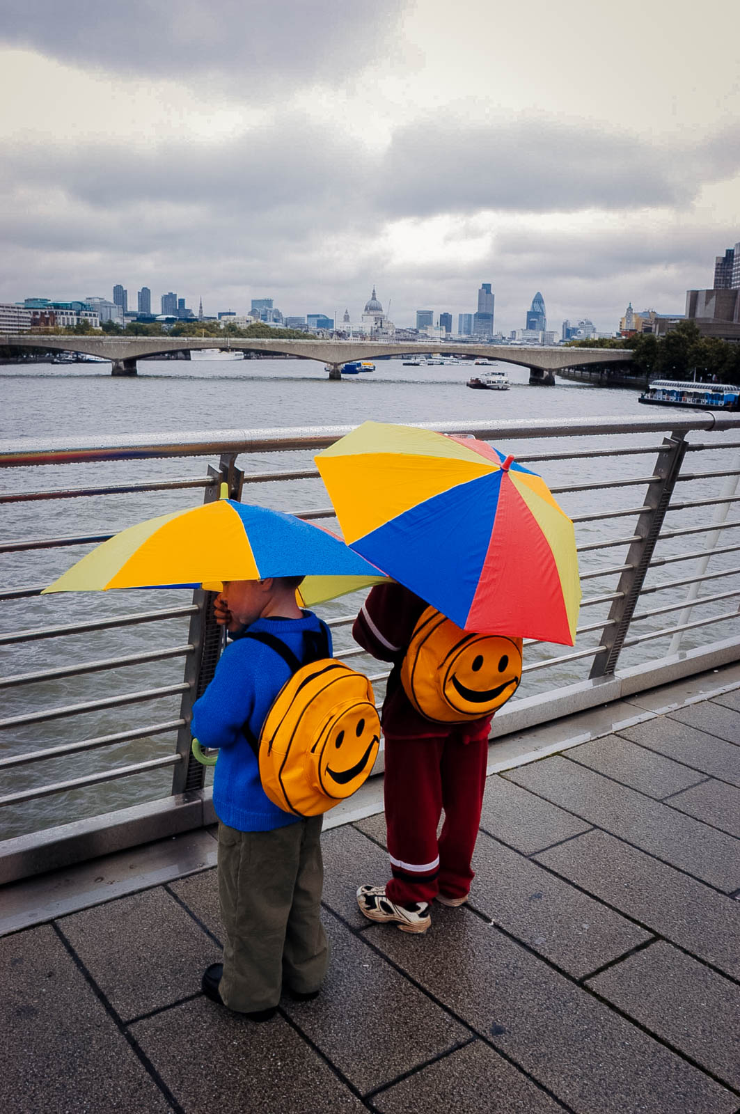 Another bank holiday weekend is forecast for rain. Jonty (right) and Tommy from Winchester walk towards London's South Bank.