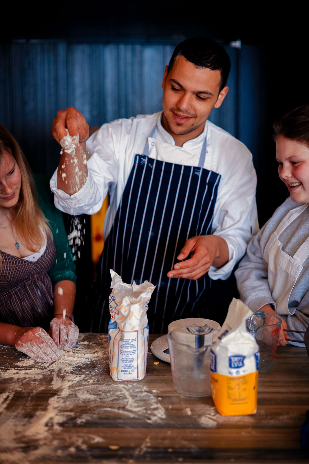 Teenagers learning cookery skills at Amici Bar & Italian Kitchen, South London