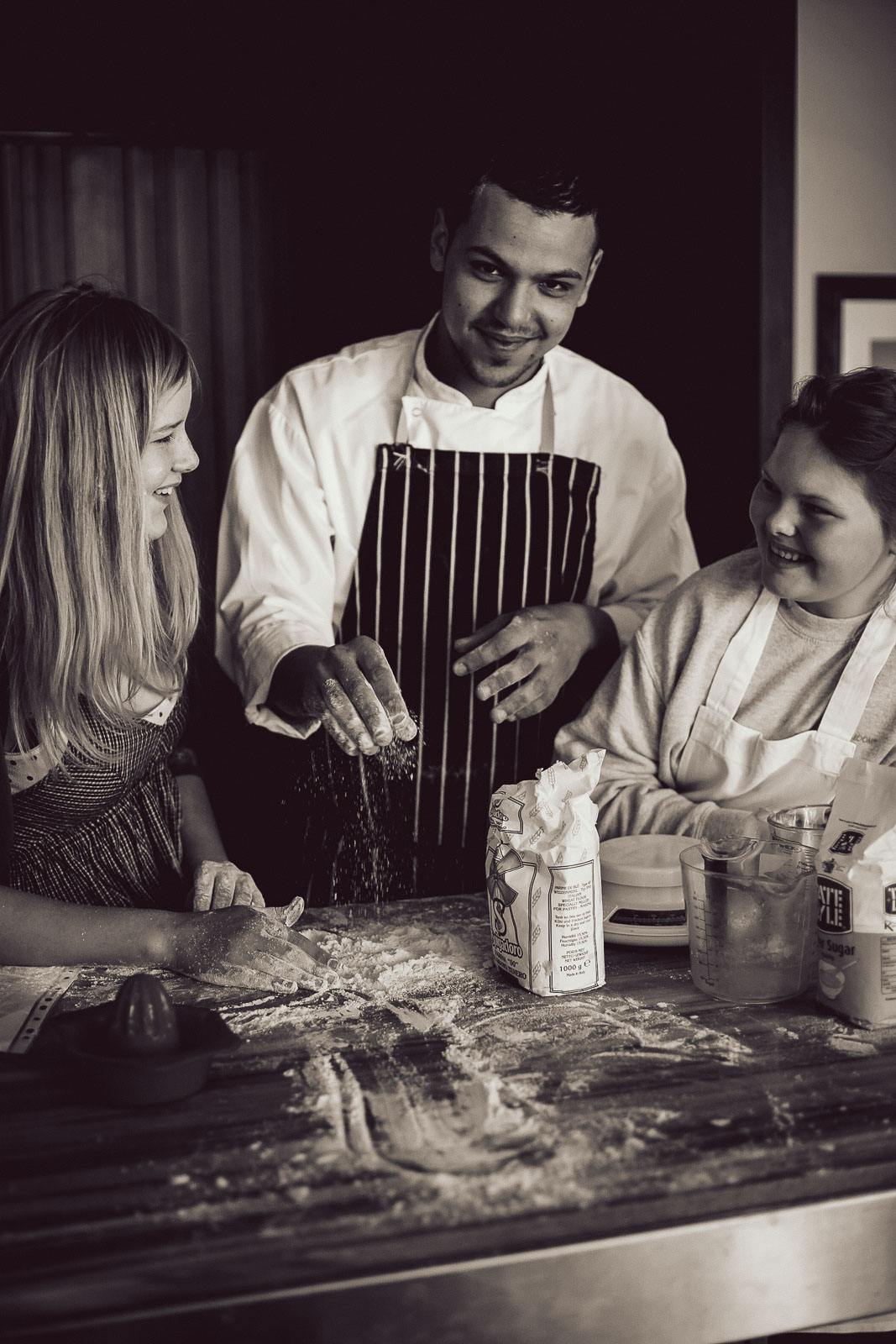 Teenagers learning cookery skills at Amici Bar & Italian Kitchen, South London