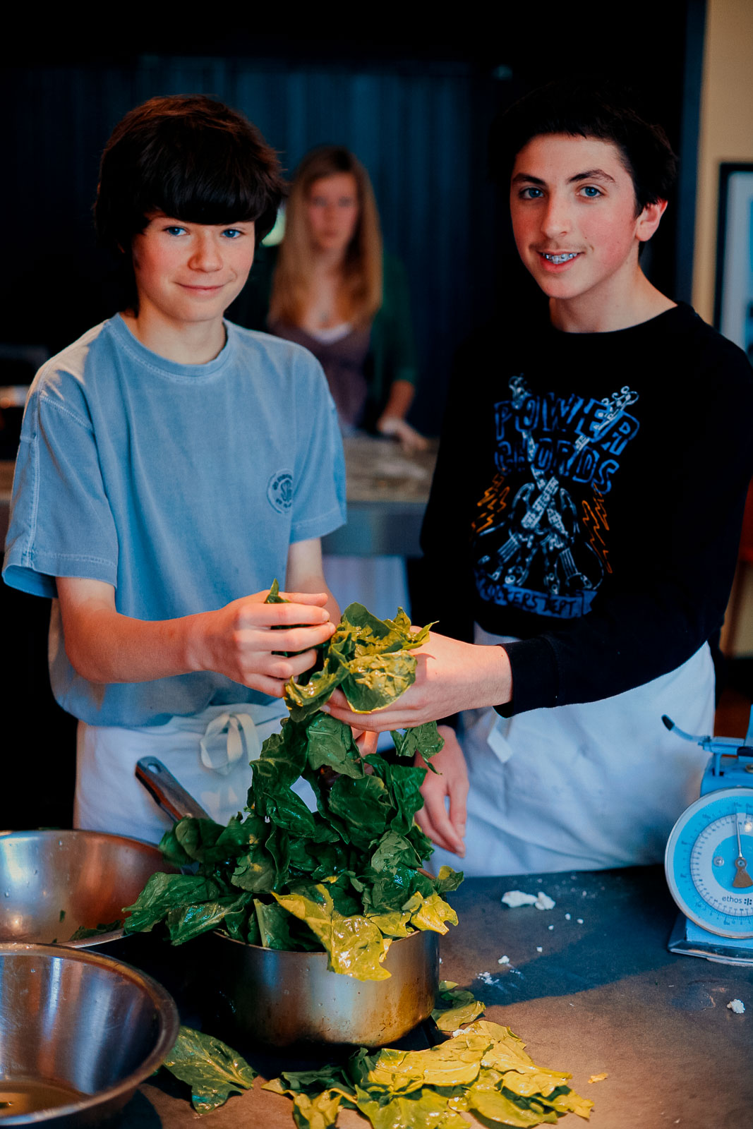Teenagers learning cookery skills at Amici Bar & Italian Kitchen, South London