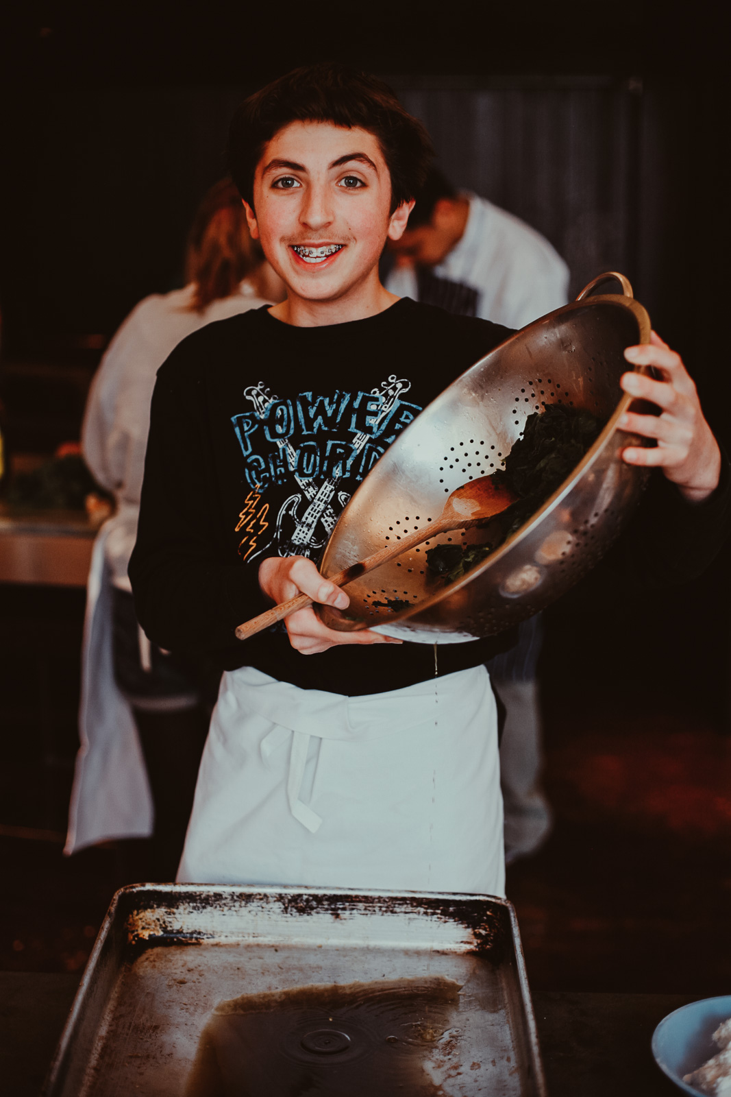 Teenagers learning cookery skills at Amici Bar & Italian Kitchen, South London