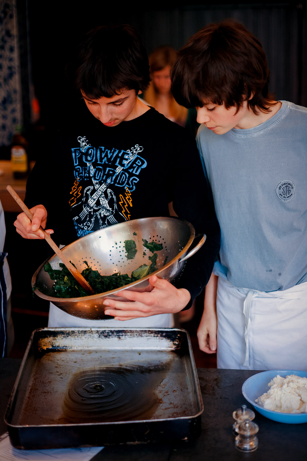 Teenagers learning cookery skills at Amici Bar & Italian Kitchen, South London