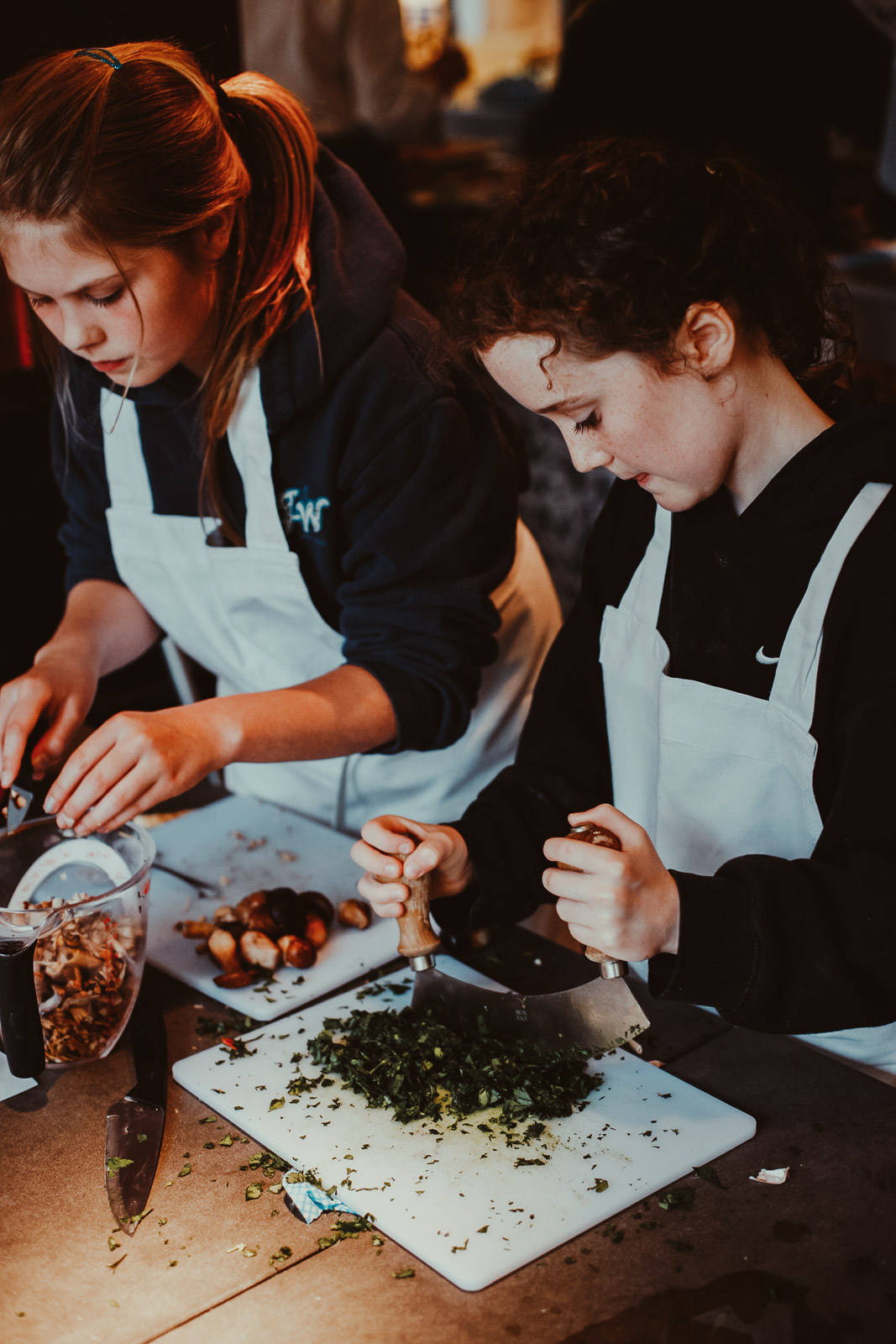 Teenagers learning cookery skills at Amici Bar & Italian Kitchen, South London